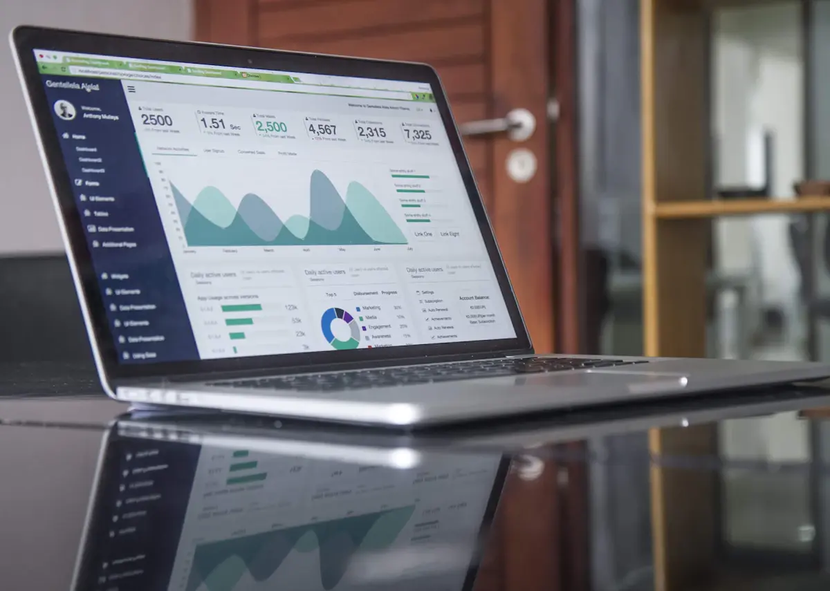 A laptop showing a live analytics dashboard with charts